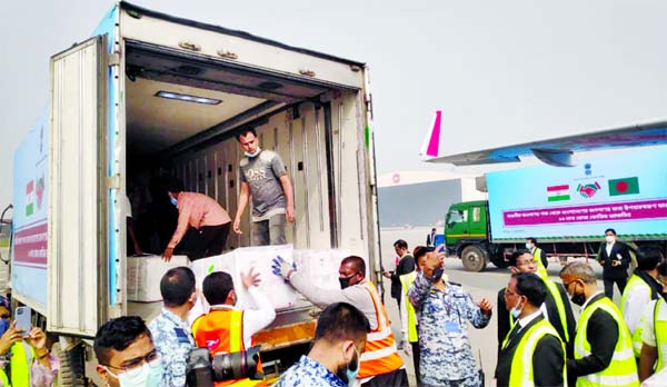 Workers unload a pickup van that carries Oxford-AstraZeneca Covid-19 vaccines which arrived from India as a gift to Bangladesh, in Dhaka, Bangladesh on Thursday.