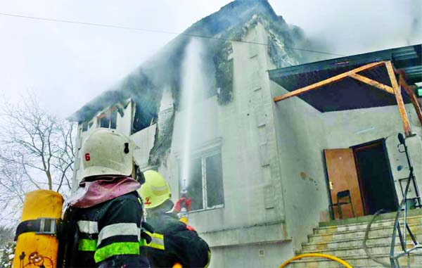 Firefighters work at the scene of the accident following a fire in nursing home in Kharkiv, Ukraine