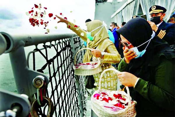 Family members of the passengers of Sriwijaya Air flight SJ 182, which crashed into the sea, react while throwing flowers and petals from the deck of Indonesia's Naval ship KRI Semarang as they visit the site of the crash to pay their tribute, at the sea