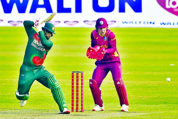 Tamim Iqbal (left) of Bangladesh plays a shot, while wicketkeeper Joshua Da Silva of West Indies looks on during the second ODI match of the Bangabandhu Bangladesh-West Indies series at the Sher-e-Bangla National Cricket Stadium in the city's Mirpur on F