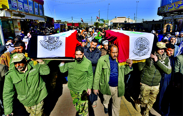 Members of Iraq's Hashed al-Shaabi force carry coffins of members of the powerful paramilitary force during a funeral procession in the holy city of Najaf.
