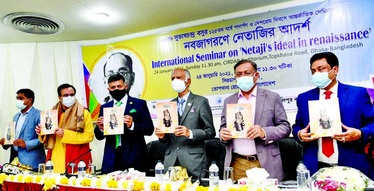 Information Minister Dr Hasan Mahmud unwraps the cover of a book titled 'Okhondo Gaurob' at an International Seminar marking the birthday of Netaji Subhas Chandra Bose at CIRDAP auditorium in the capital on Sunday.