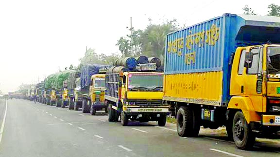 Goods-laden covered vans and trucks from 21 Southern districts get stuck in a long tailback as vehicular movement disrupted due to dense fog at Daulotdia Ghat in Rajbari district on Sunday.