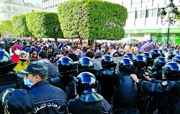 Police officers stand guard as demonstrators take part in an anti-government protest in Tunis, Tunisia.