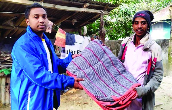 Swapno Toru Samajik Sangothon leaders distribute over 100 pieces of good quality blankets among the cold hit people living on Chandpur Railway Station platforms in Chandpur district town on Sunday.