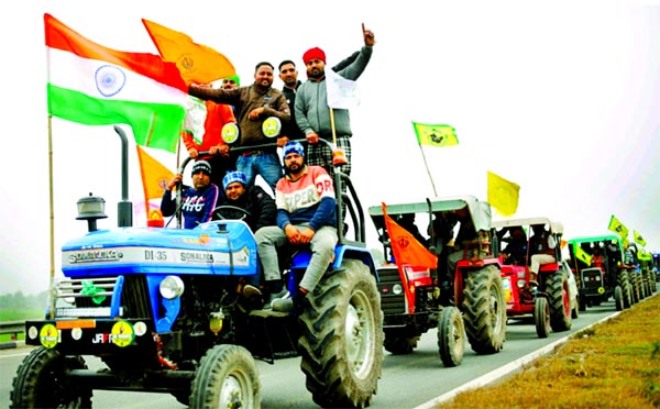 Farmers participate in a tractor rally to protest against the newly passed farm bill, on a highway on the outskirts of New Delhi, India, January7, 2021.