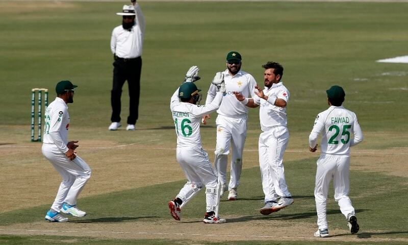 Pakistan's spinner Yasir Shah (second from right) celebrates with teammates on the dismissal of South Africa's batsman Faf du Plessis during the first day of the first cricket test match Against South Africa at the National stadium in Karachi on Tuesday