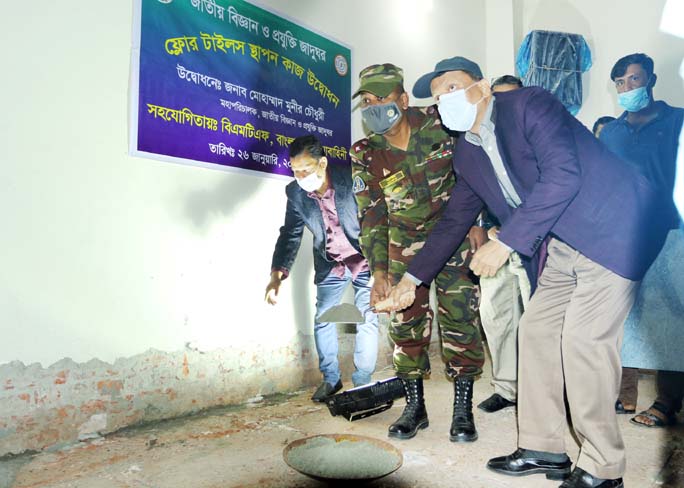 Director General of the city's National Science and Technology Museum Munir Chowdhury, among others, at the inauguration work of floor tiles setting in the museum on Tuesday.