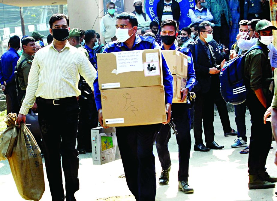 Election Commission staff carrying election materials from MA Aziz Stadium Gymnesium Hall in the city amid tight security on the day before Chattogram City Corporation polls on Tuesday.