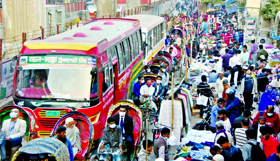 Rickshaw pullers take a risky trip on a narrow road in the capital's Purana Paltan area on Tuesday amid ongoing construction work of Dhaka Metro Rail Project.