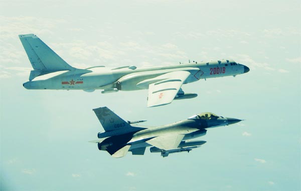An H-6 bomber of Chinese PLA Air Force flies near a Taiwan F-16 on February 10, 2020