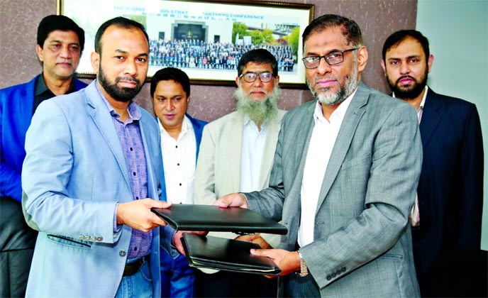 Ahamad Hossain, General Manager of BASIC Bank Limited and Mohammad Nurul Afsar, Deputy Managing Director of Electro Mart Limited (EML), exchanging a MoU signing document at EML head office in the city recently. Under the deal, Credit Card holders of the b