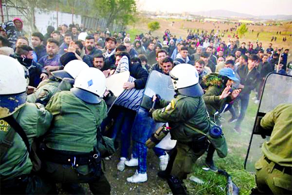 Police clashes with migrants outside of a refugee camp in Diavata, Greece.