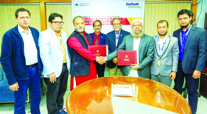 Mominul Haque Majumder, Treasurer of Daffodil International University and Md. Rafiqul Alam Bhuiyan, DMD of Pragati Life Insurance Limited, exchanging document after signing a MoU at VC office of the university on Tuesday. The deal was signed to ensure se