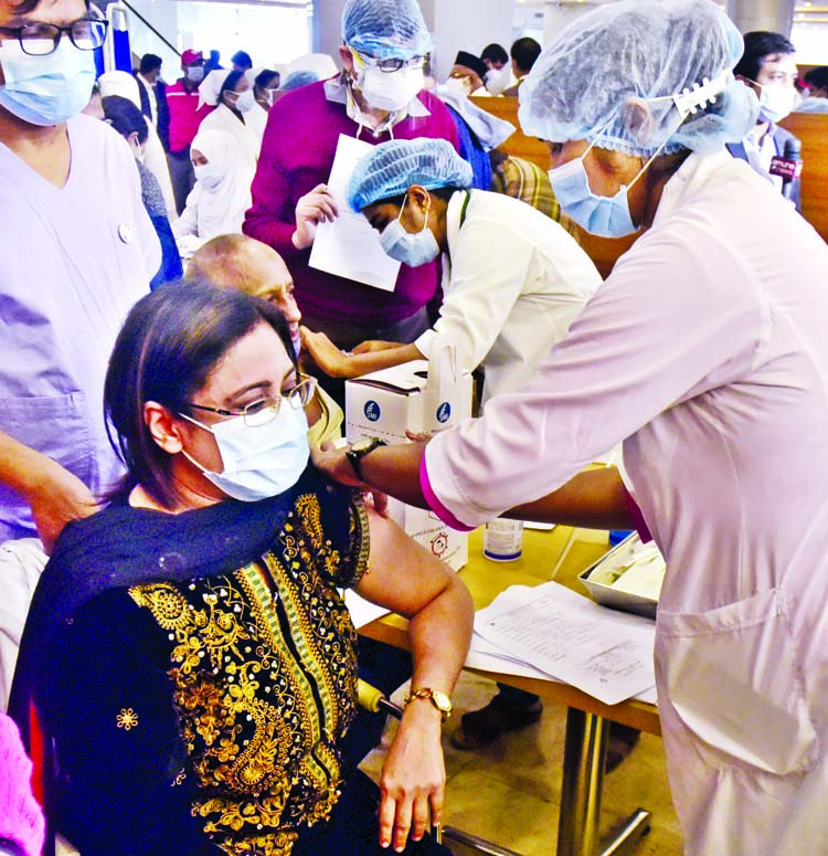 A health worker administers the AstraZeneca-Oxford vaccine to a physician during the second day of vaccination campaign at Bangabandhu Sheikh Mujib Medical University in Dhaka on Thursday.
