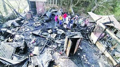 Fire Service and Civil Defence personnel working to douse the fire that gutted the house of Lt Cdr Moazzem Hossain at the West Dumritola area under Pirojpur Sadar upazila Friday morning.