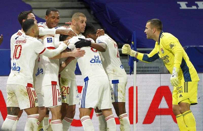 Lyon players celebrate their second goal during the French Ligue 1 soccer match between Lyon and Bordeaux in Lyon, France on Friday.