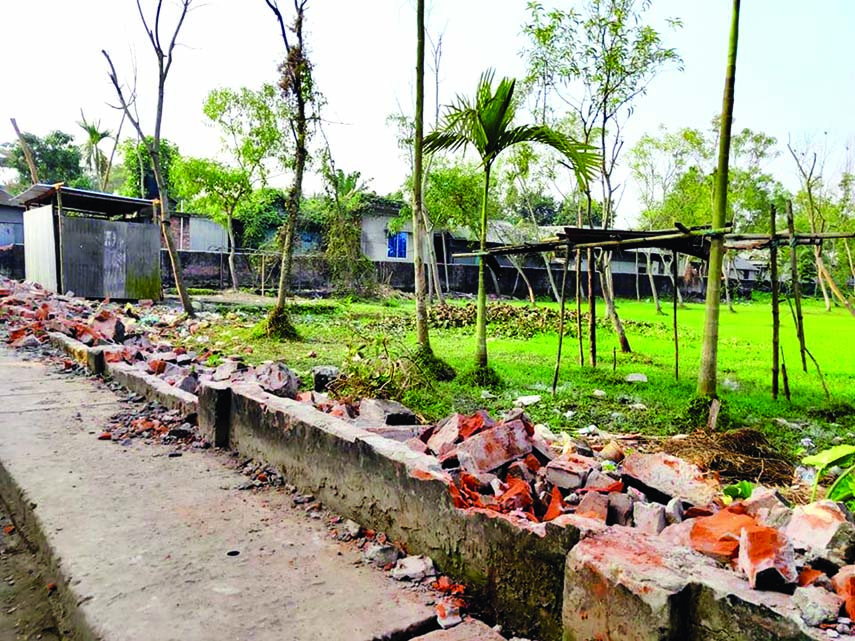 Land grabbers break 100/150 feet boundary wall of a disputed land behind Muktagacha Police Station in Mymensingh on Friday night in violation of court's injunction.