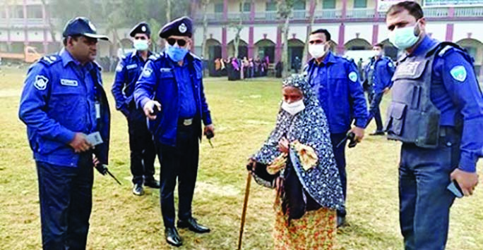 Chandpur SP Mahbubur Rahman came forward to this elderly woman of 80 -year- old Monoja Begum of Toraghar area and helped her to cast her vote at Pilot High School centre during Hajiganj Municipal poll held peacefully on Saturday.