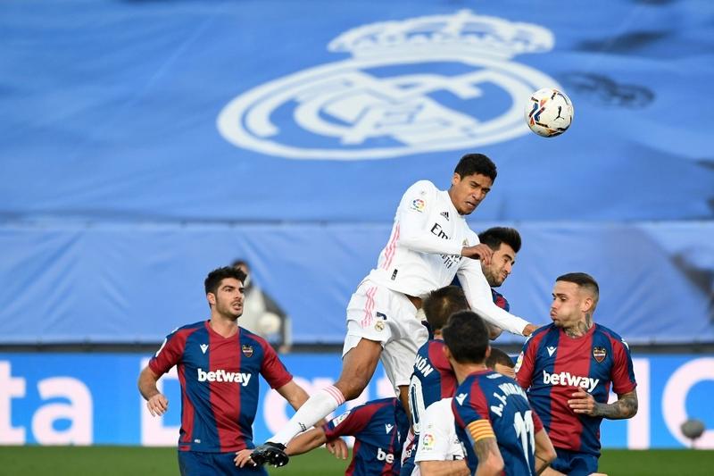 Real Madrid's defender Raphael Varane heads the ball during the Spanish league football match Real Madrid CF against Levante UD at the Alfredo di Stefano stadium in Valdebebas, on the outskirts of Madrid on Saturday.