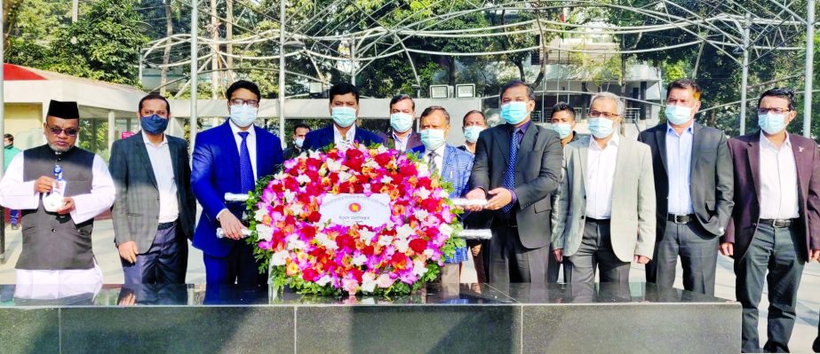 Comptroller General of Accounts Nurul Islam along with other officials pays floral tributes at the portrait of Father of the Nation Bangabandhu Sheikh Mujibur Rahman at 32, Dhanmondi in the city on Monday.