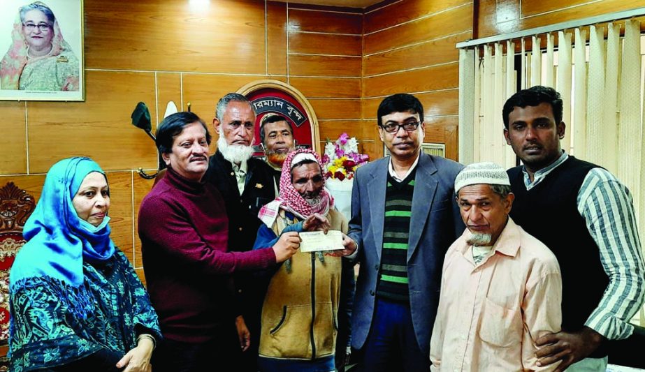 Feni Zilla Parishad Chairman Khairul Basher Majumder hands over cheque of grant to Md Syed and Abul Kashem on Monday morning.