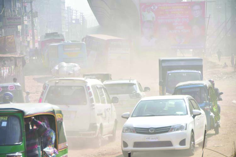 Vehicles move amid a cloud of dust on Kadamtoli Road in the capital. This photo was taken on Wednesday.