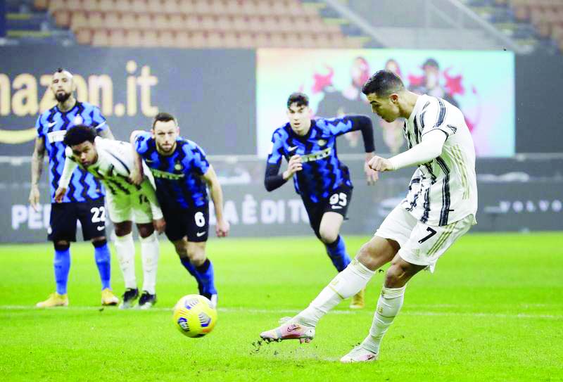 Juventus' Cristiano Ronaldo scores a penalty during the Italian Cup semi-final first leg soccer match between Inter Milan and Juventus at the San Siro stadium, in Milan, Italy on Tuesday.