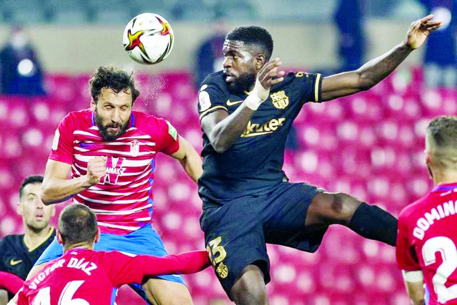 Granada's defender German Sanchez (left) heads the ball with Barcelona's defender Samuel Umtiti during the Spanish Copa del Rey (King's Cup) quarter-final football match at Nuevo Los Carmenes stadium in Granada on Wednesday.