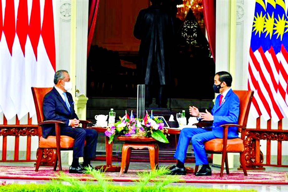 Indonesian President Joko Widodo talks with Malaysian Prime Minister Muhyiddin Yassin during a meeting at the Presidential Palace in Jakarta, Indonesia, on February 5, 2021.