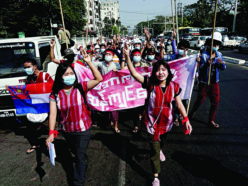 Protesters hold up the three finger salute during a demonstration against the military coup in Yangon on Saturday.