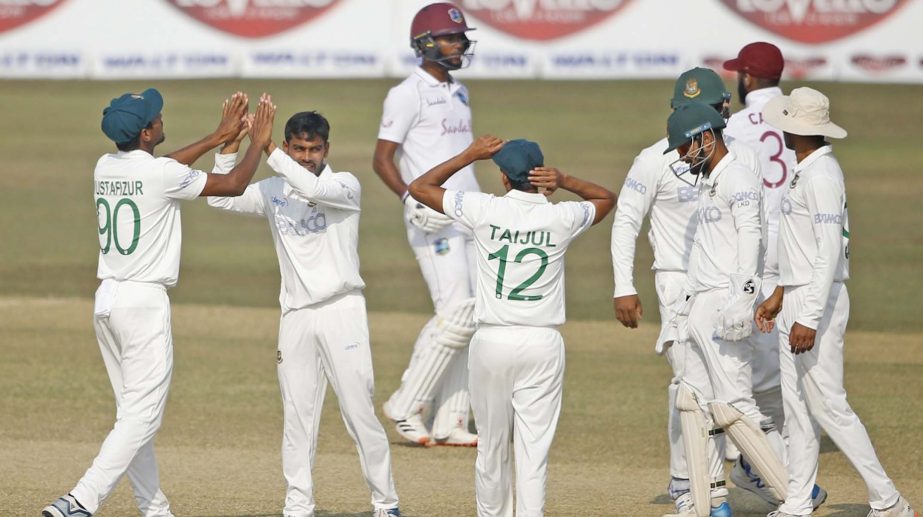 Mehidy Hasan Miraz (second from left) celebrating with his teammate Mustafizur Rahman after dismissal of a wicket of West Indies in the second innings on the fourth day at the Zahur Ahmed Chowdhury Stadium in Chattogram on Saturday.