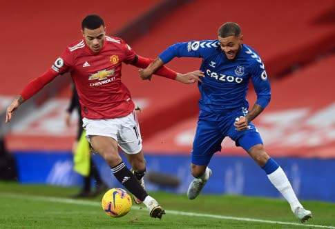 Manchester United's striker Mason Greenwood (left) is challenged by Everton's striker Josh King during their English Premier League match at Old Trafford in Manchester, northwest England on Saturday.