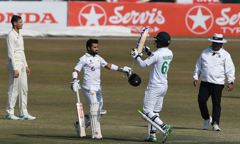 Mohammad Rizwan (left) celebrates with his teammate Nauman Ali (second from right) after scoring a century during the fourth day of the second Test cricket match between Pakistan and South Africa at the Rawalpindi Cricket Stadium in Pakistan on Sunday.