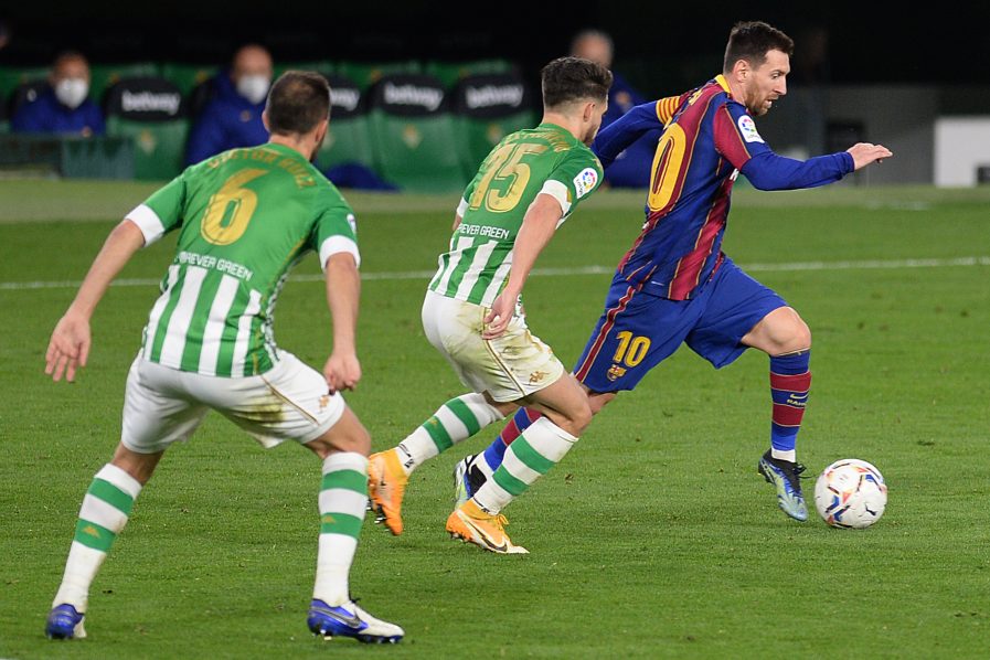 Barcelonaâ€™s Argentinian forward Lionel Messi (R) challenges Real Betisâ€™ Spanish defender Victor Ruiz and Real Betisâ€™ Spanish defender Alex Moreno (C) during the Spanish league football match between Real Betis and FC Barcelona at the