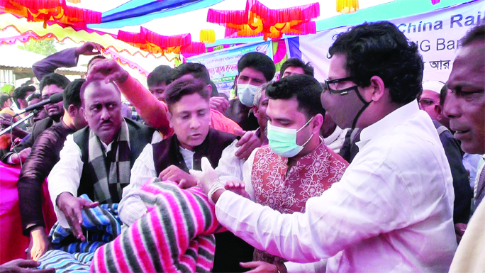 State Minister of ICT Division Zunaid Ahmed Palak distributing blankets among the cold- hit people at Tarai Bazar as chief guest on Sunday.