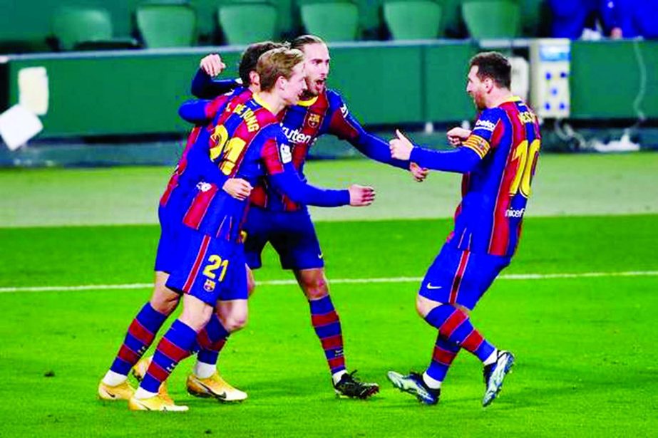 Barcelona's Lionel Messi is congratulated by Barcelona's Pedri after scoring his first goal during La Liga soccer match against Betis at the Benito Villamarin stadium in Seville, Spain on Sunday.