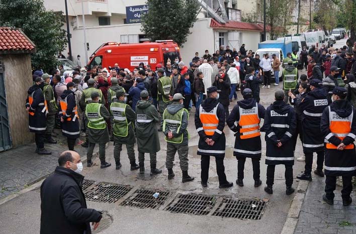 Police and emergency services outside the house where as many as 28 people died during a flood in Tangier, Morocco.