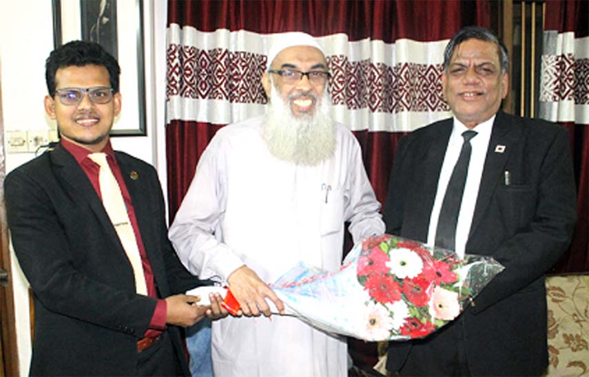 Principal Dr. Abdul Karim presenting a bouquet to Advocate Sami Uddin as he becomes the President of Kutupalang High School Managing Committee