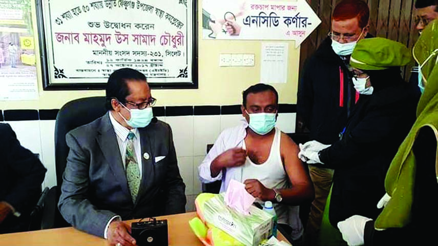 Mahmud Us Samad Chowdhury, MP, receives a Covid-19 vaccine jab at the Fenchuganj Upazila Health Complex in Sylhet on Sunday.
