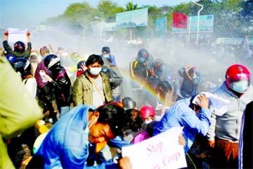 Police fire a water cannon at protesters rallying against the military coup and to demand the release of elected leader Aung San Suu Kyi, in Naypyitaw, Myanmar.