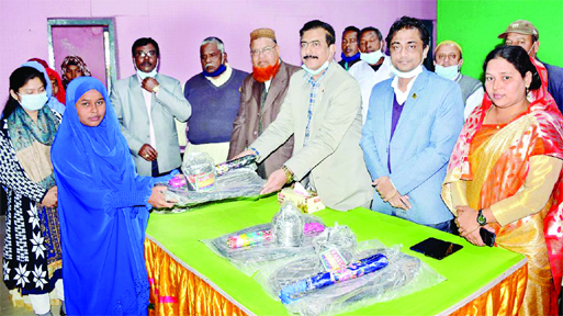 Manoranjan Shil Gopal, MP, distributes schooling materials among the students at Kaharole Upazila auditorium in Dinajpur on Tuesday.