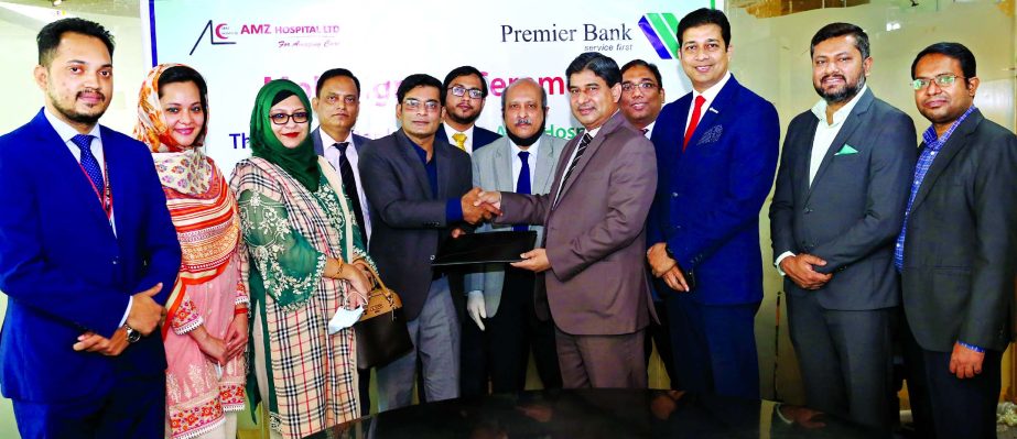 Golam Awlia, AMD of Premier Bank Limited and Mahmood Hossain, Advisor of AMZ Hospital Limited, exchanging an agreement document at the bank head office in the city recently. Under the deal, Credit & Debit cardholders of the bank will get up to 25 percent