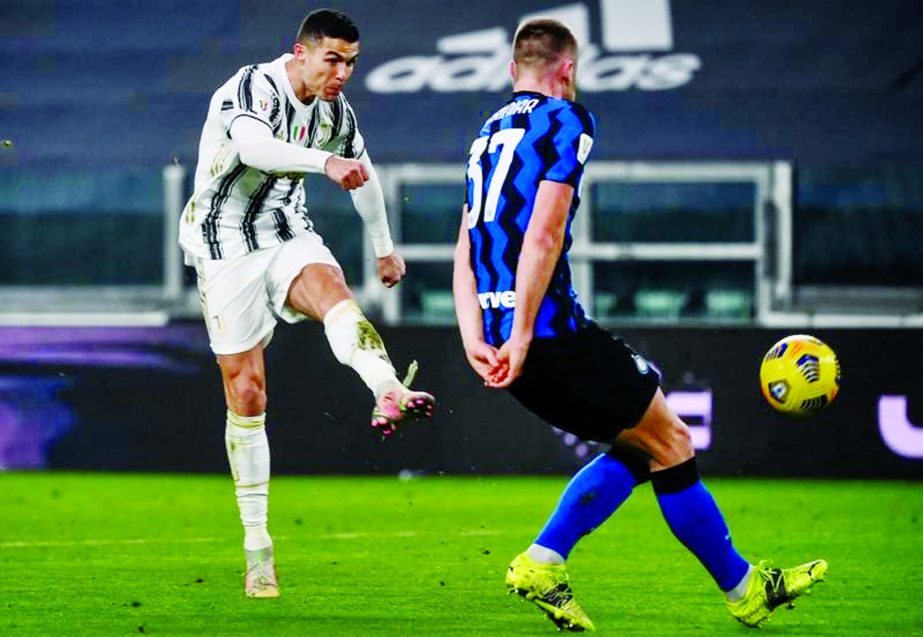 Juventus' forward Cristiano Ronaldo (left) shoots past Inter Milan's defender Skriniar during the Italian Cup semifinal second leg football match between Juventus and Inter Milan at the Juventus stadium in Turin on Tuesday.