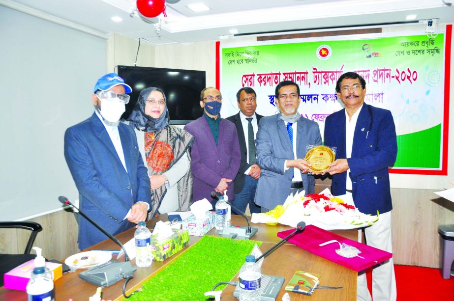 Babu Subodh Ranjon Das, receiving the Tax Card and crest for 1st highest tax payee of Narshindi District of FY-2019-2020 from Md. Lutful Azim, Tax Zone-10 Commissioner at a function at NBR head office in the city on Thursday.