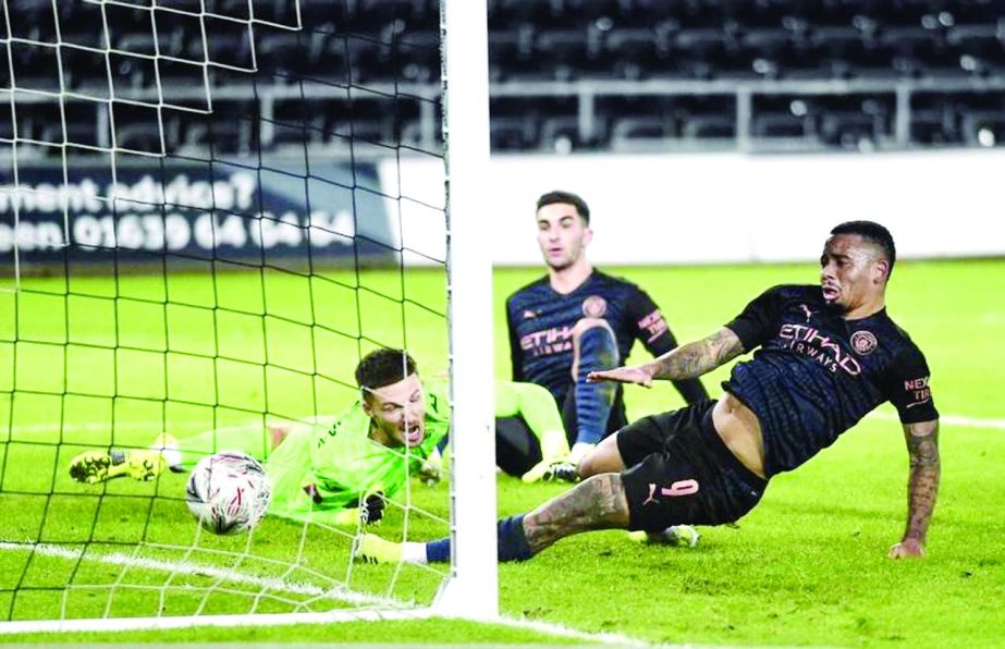 Swansea City's goalkeeper Freddie Woodman (left) and Manchester City's Gabriel Jesus (right) watch the ball cross the goal-line as Manchester City's defender Kyle Walker (not seen) scores his team's first goal during the English FA Cup fifth round foo