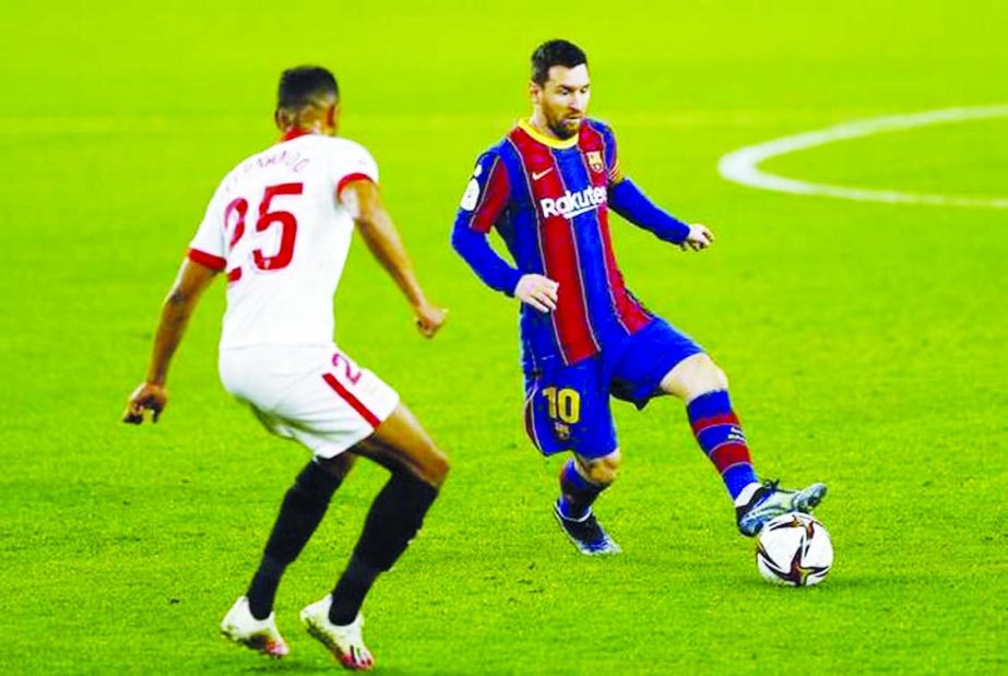 Messi (right) in action with Sevilla's Fernando during the first leg of Copa del Rey semi final at Ramon Sanchez Pizjuan, Seville, Spain on Wednesday.