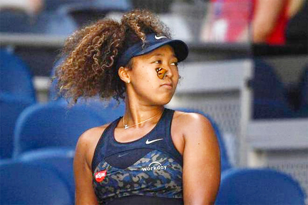 A butterfly lands on Japan's Naomi Osaka as she plays against Tunisia's Ons Jabeur in the their third-round match of the Australian Open in Melbourne on Friday.