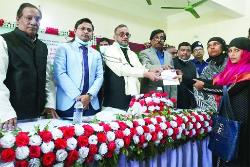 Environment, Forests and Climate Change Minister Md Shahab Uddin providing financial assistance to the helpless and poor people at a function held at Juri Upazila Parishad Auditorium in Moulvibazar district on Saturday morning.