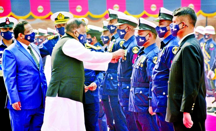Home Minister Asaduzzaman Khan MP adorns badges as the chief guest to the members of Bangladesh Coast Guard at its 26th Founding Anniversary and Awards Presentation Ceremony-2021 in the capital on Sunday.